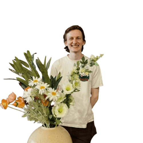 Richard of Lee Pottery holding a vase of flowers